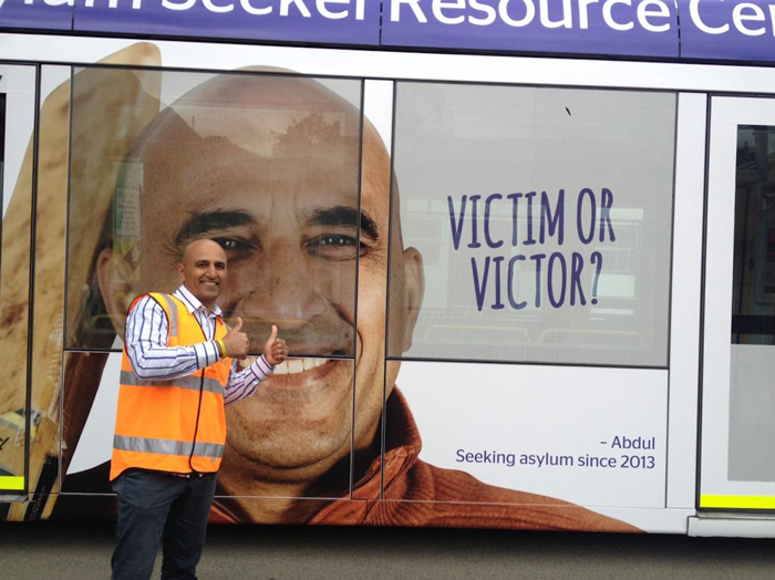 Photo of Abdul and his image on a tram.
