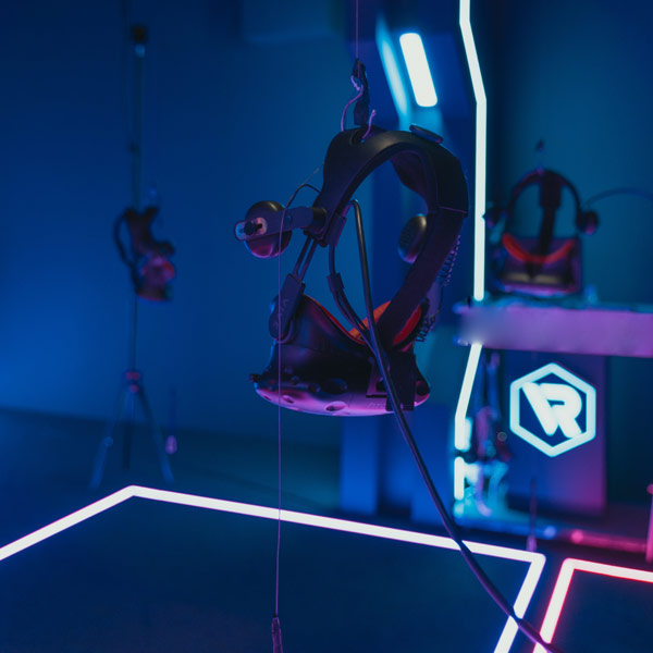 VR headset hanging in neon room
